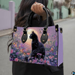 Outdoor view showcasing black cat butterfly artwork held alongside an urban walkway.