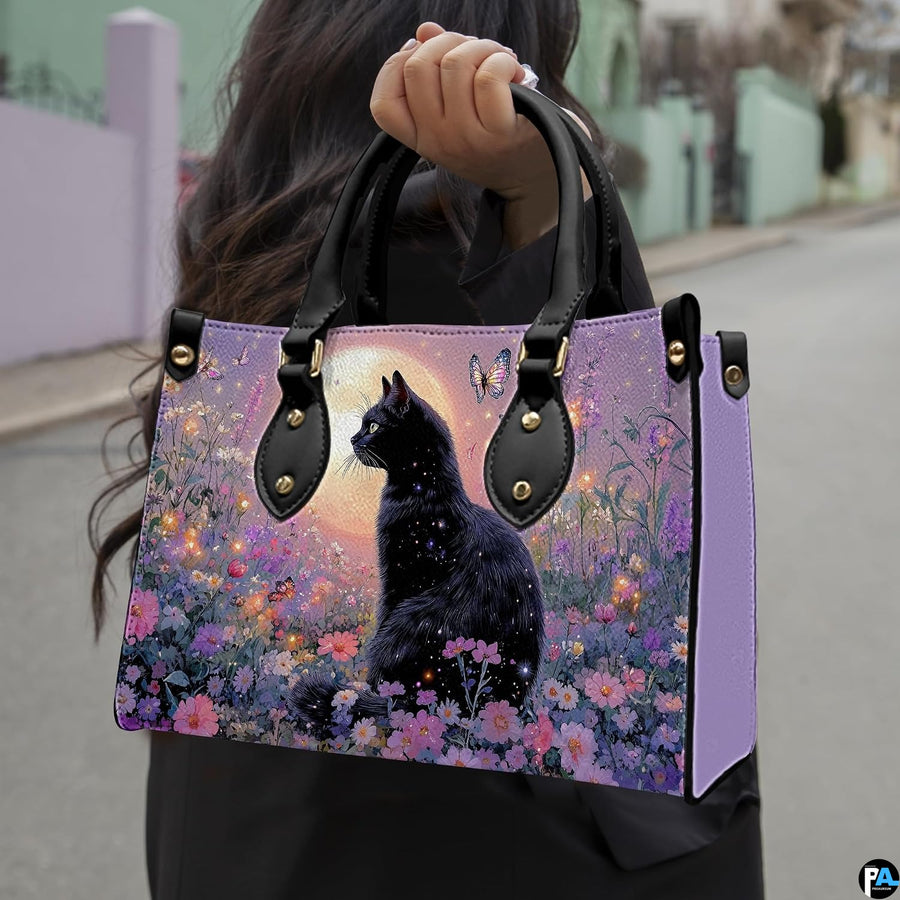 Outdoor view showcasing black cat butterfly artwork held alongside an urban walkway.