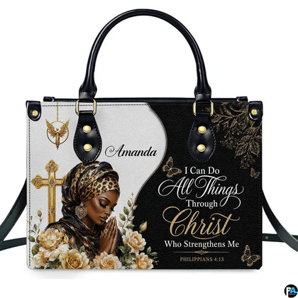 Front view of handbag featuring praying Black woman portrait with leopard wrap and golden cross