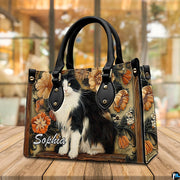 Angled view highlighting black white cat art floral motif along side profile on rustic wooden surface.
