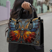 Angled view showing stained glass butterfly handbag and matching zip wallet side by side