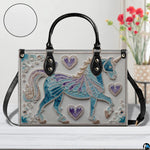 Side profile view showing structured silhouette and black carrying handles of the handbag.
