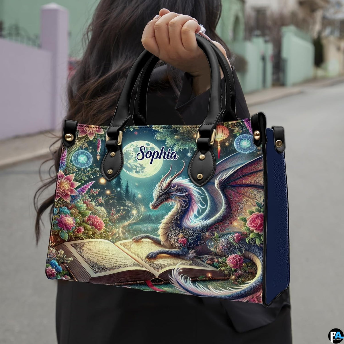 Celestial dragon handbag held outdoors by top handles displaying the vibrant moonlit garden fantasy artwork.