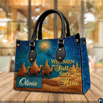 Close-up front view of matching zippered wallet showing biblical desert caravan scene