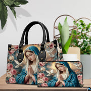 Virgin Mary devotional handbag and matching zippered wallet displayed on wooden table.