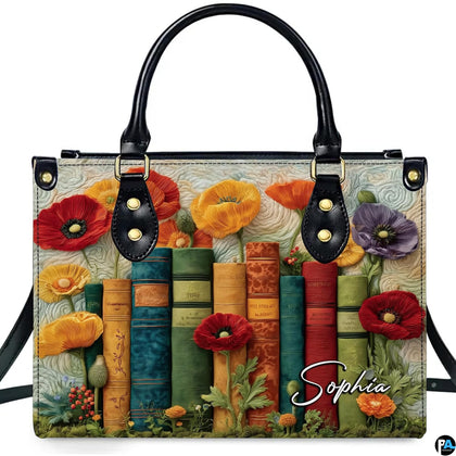 Studio display of Blooming Poppy Library Books Handbag with colorful poppies and vintage book spines on ivory backdrop.