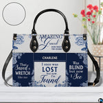 Coordinated blue floral handbag and matching wallet set on white surface