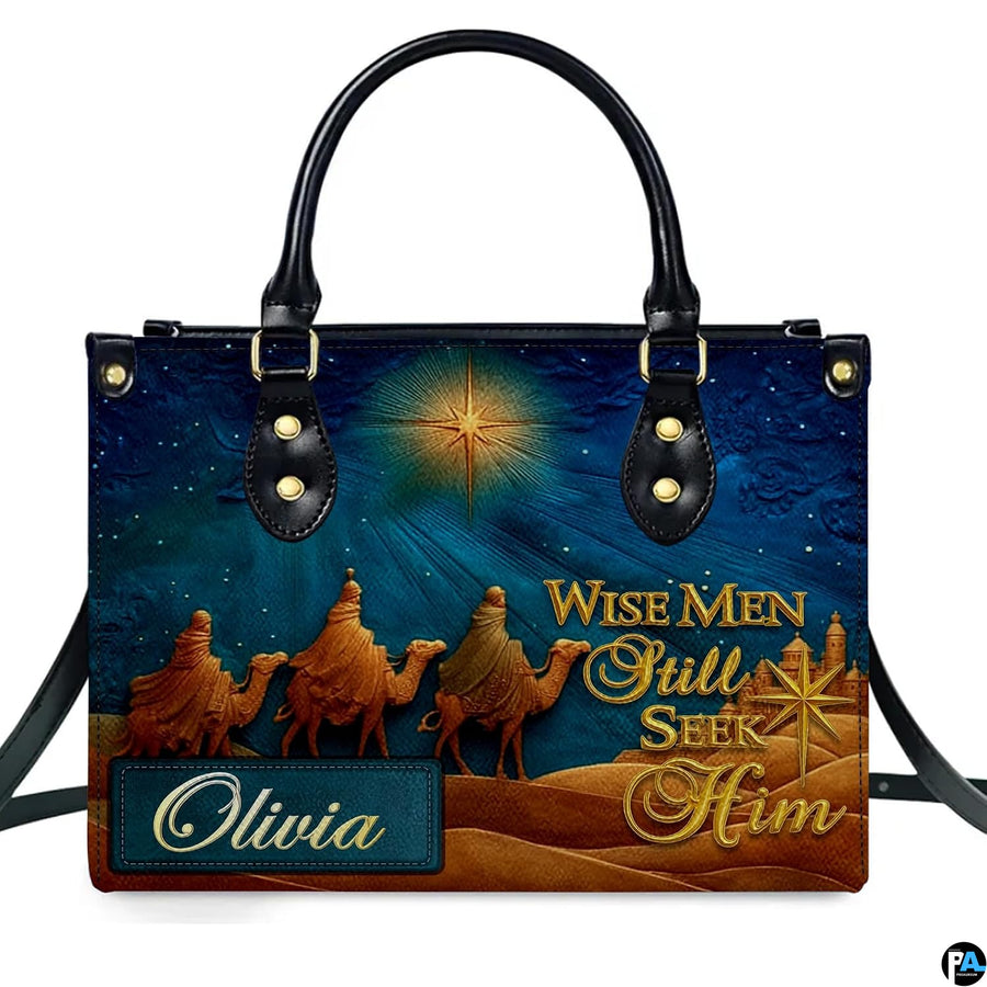 Close-up front view of handbag showing three camel travelers and shining celestial star