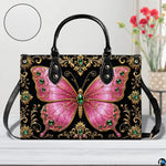 Front tabletop presentation of pink jeweled butterfly artwork placed beside floral vase and circular texture inset.
