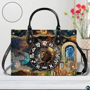 Celestial Lion Satchel Handbag resting on a white table beside floral bouquet with texture inset.