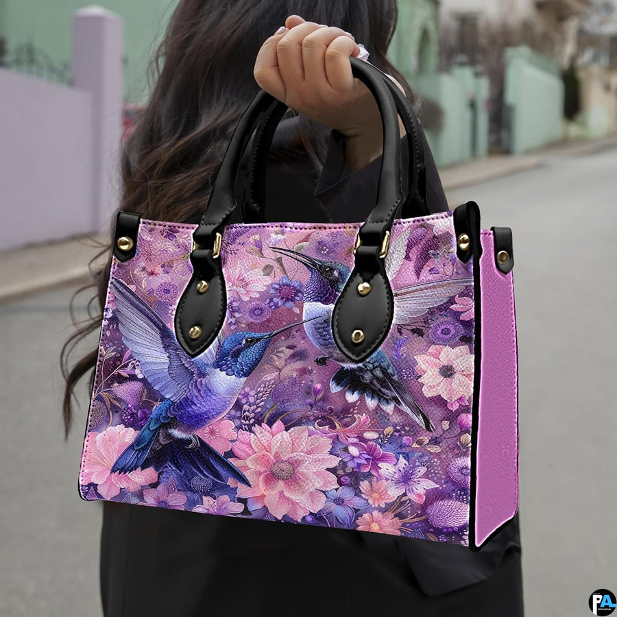 Angled display of purple botanical purse shown alongside coordinating zippered companion wallet.