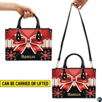 Side profile of Christmas bow handbag highlighting structured silhouette and comfortable carrying handles.
