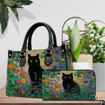 Black cat garden art resting beside green potted plants on a wooden surface.
