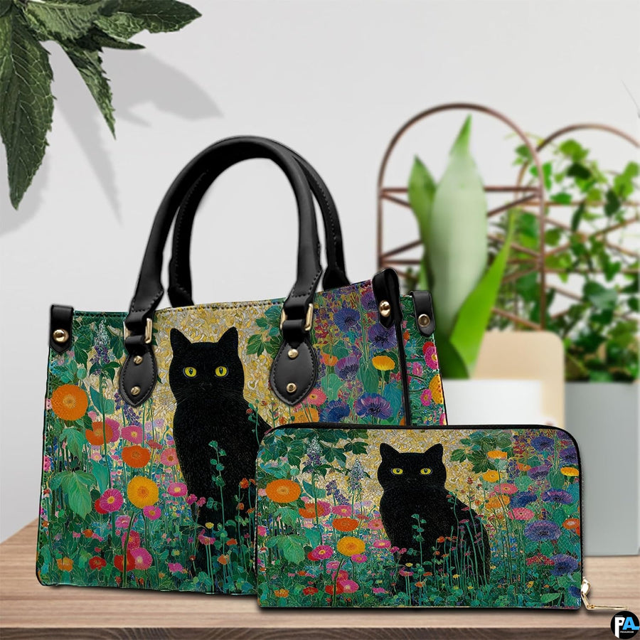 Black cat garden art resting beside green potted plants on a wooden surface.
