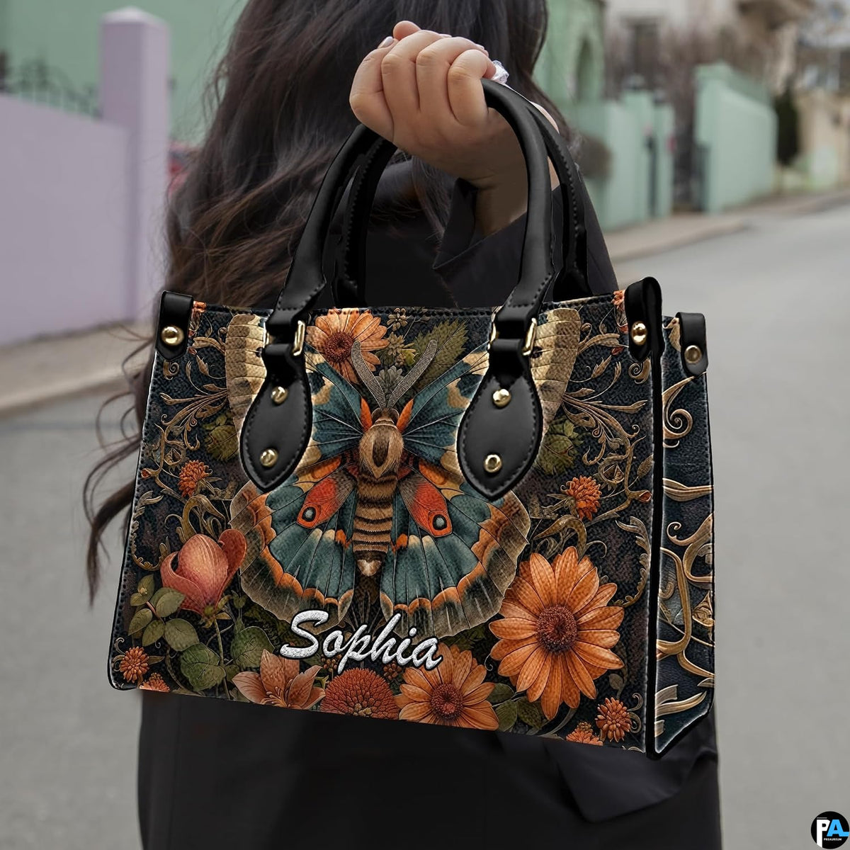 Model carrying vintage botanical moth handbag outdoors