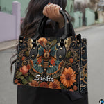 Model carrying vintage botanical moth handbag outdoors