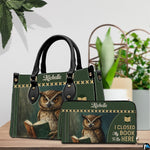 Reading owl handbag and matching wallet set styled on a wooden tabletop with indoor plants.