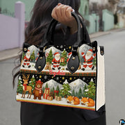 Detailed front view of handbag showcasing two-tiered holiday illustration of Santas, reindeer, and winter foxes.