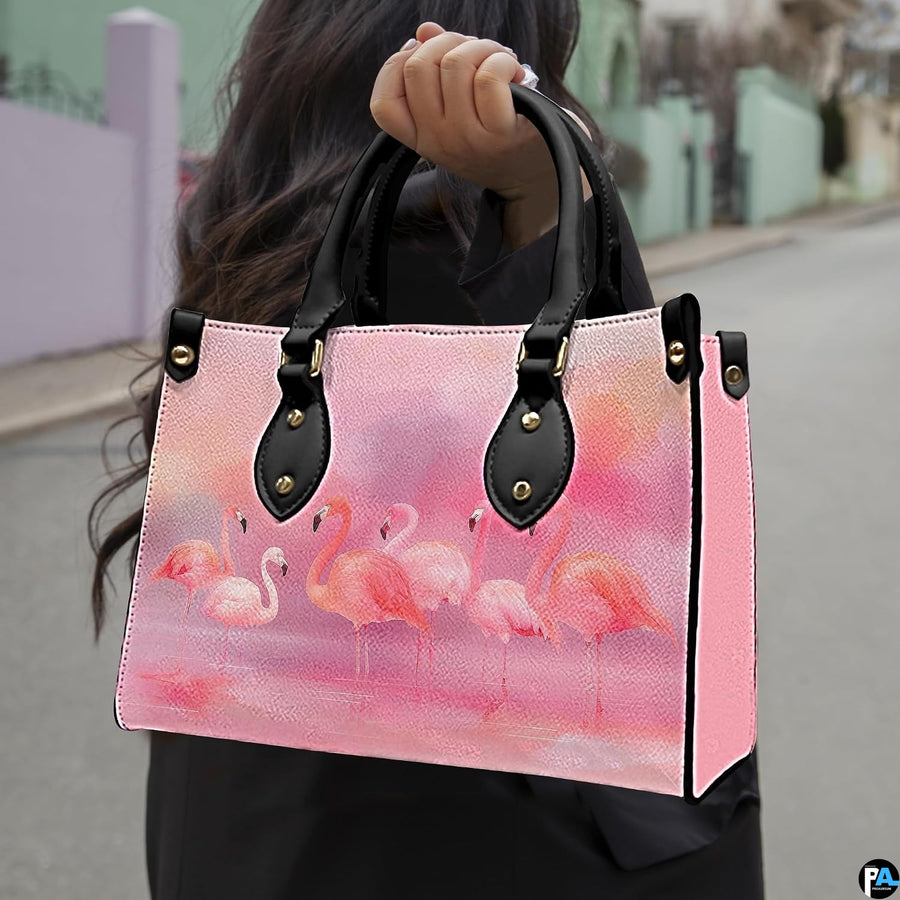 Outdoor lifestyle view of model carrying the pastel flamingo flock handbag.