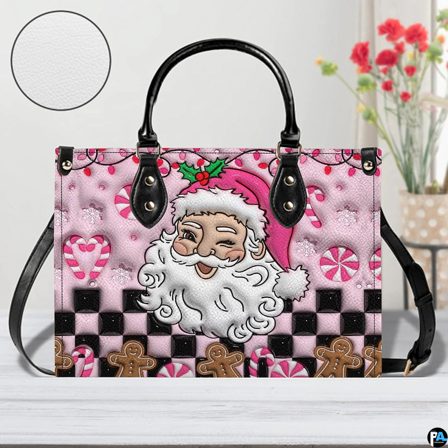 Pink Santa holiday handbag displayed in studio setting with circular texture swatch inset.