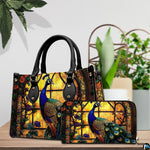 Peacock handbag and wallet with glowing amber window and floral arches