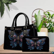 Tabletop display showing floral butterfly handbag and matching zip wallet beside indoor plants
