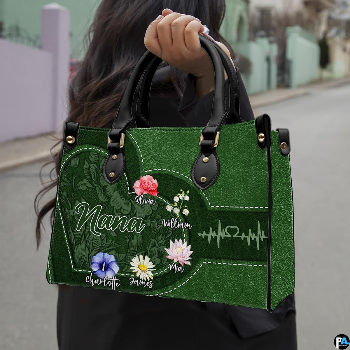 Front view of green handbag featuring contoured heart outline, watercolor garden blossoms, and pulse line.