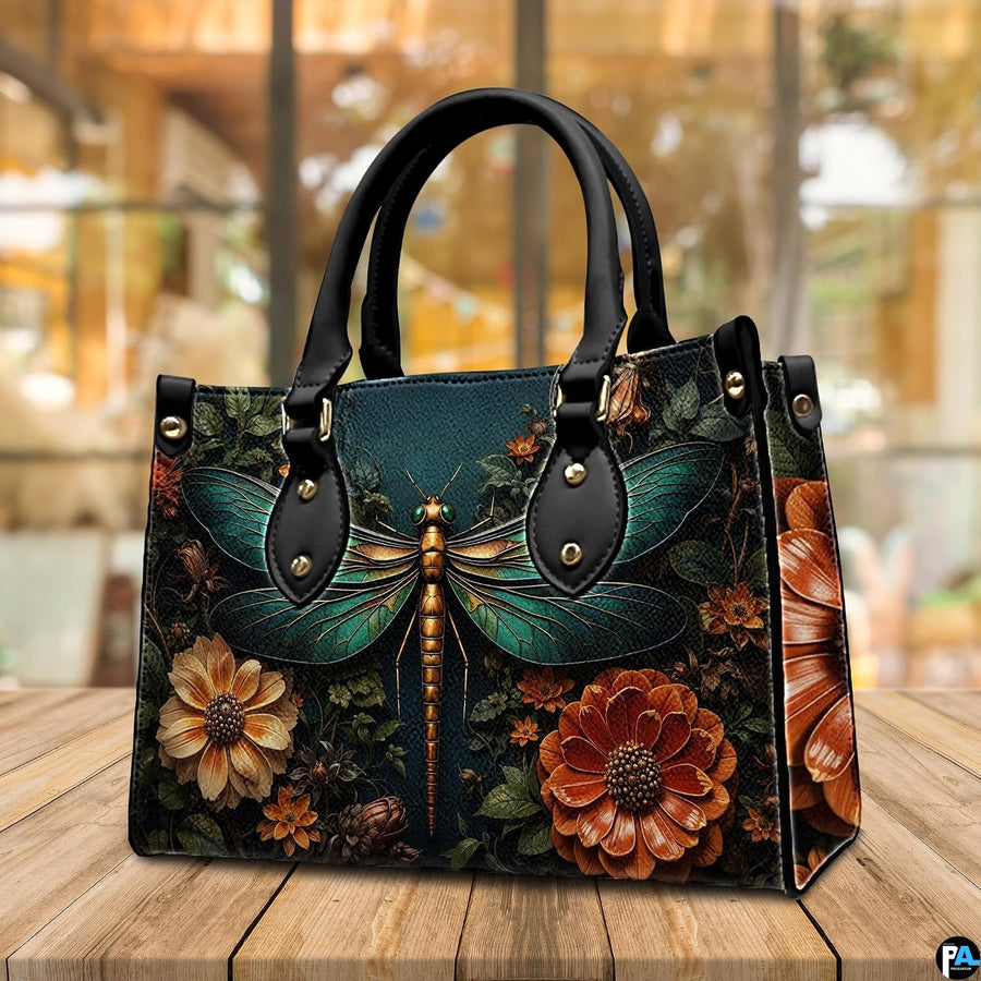 Side profile of dragonfly handbag showing continuous autumn botanical floral print along gusset