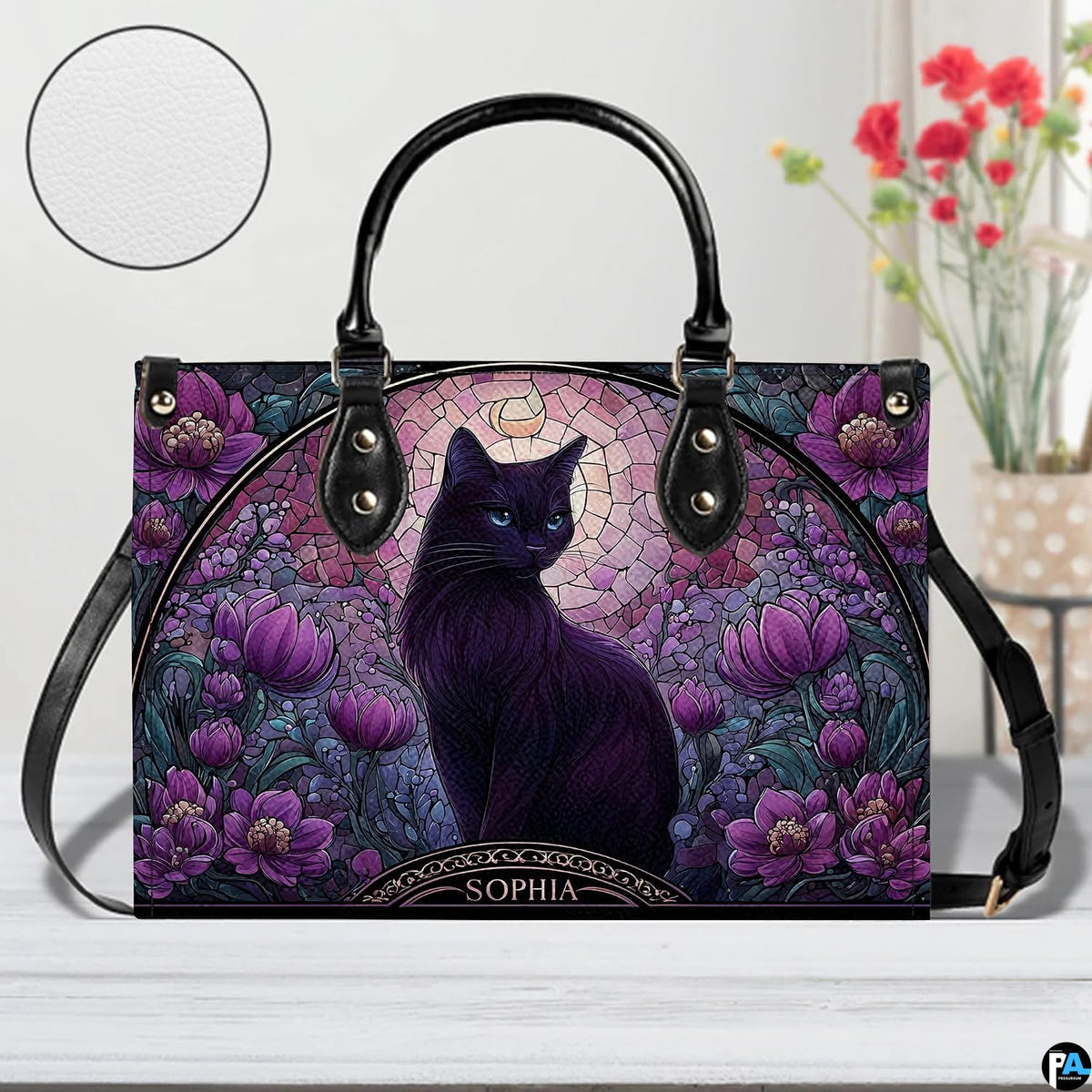Studio view on white tabletop highlighting stained glass black cat illustration and purple floral arch.