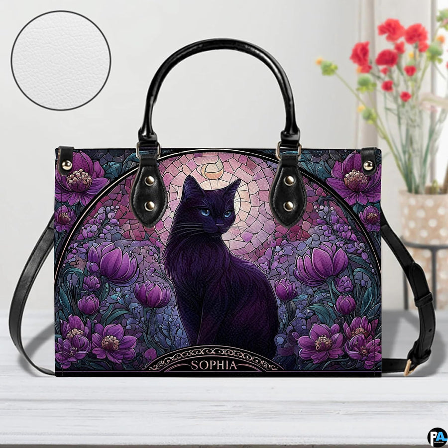 Studio view on white tabletop highlighting stained glass black cat illustration and purple floral arch.