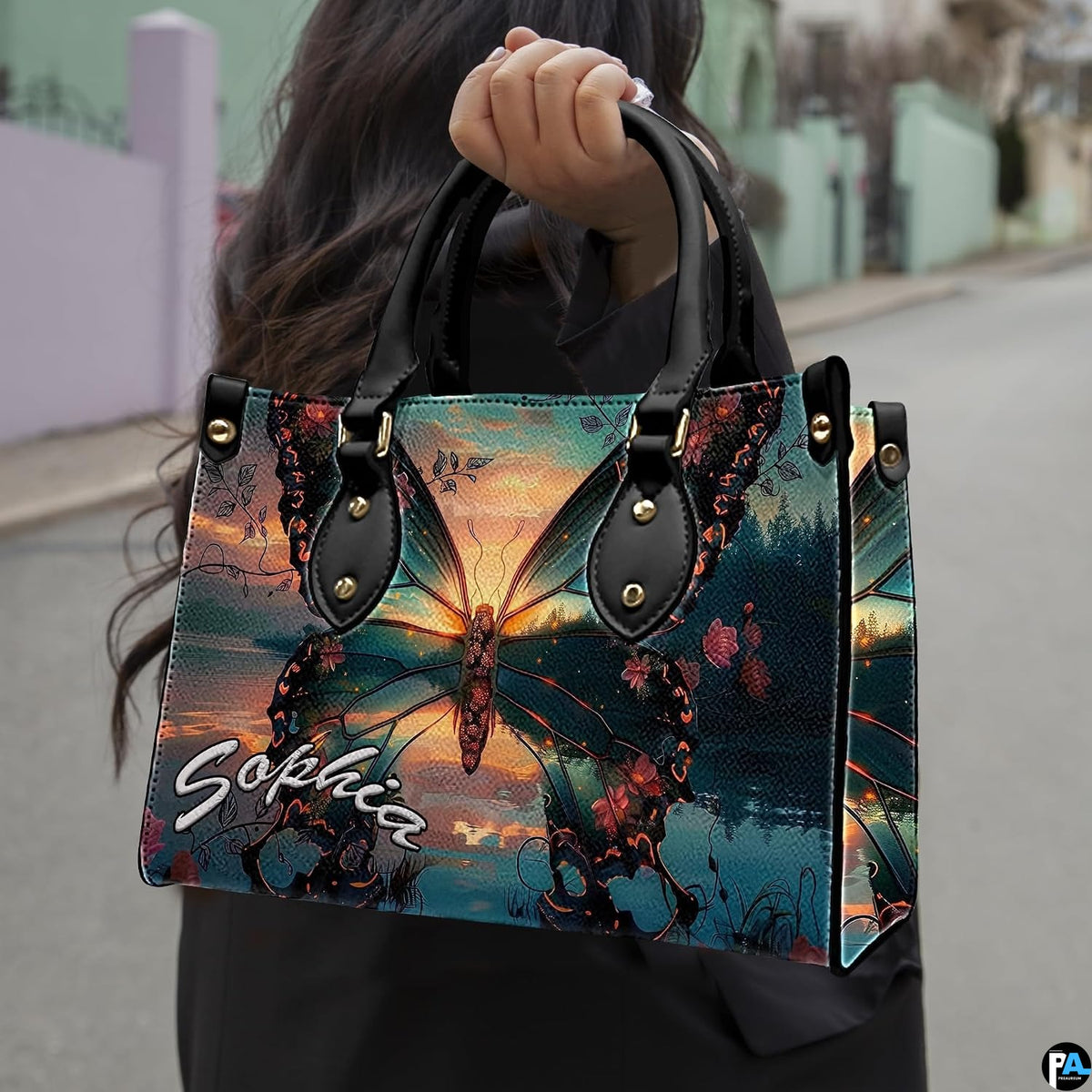 Model carrying sunset lake butterfly handbag outdoors