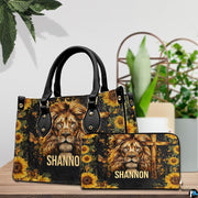 Detailed view of lion cross handbag showing handle hardware and intricate lion facial rendering.
