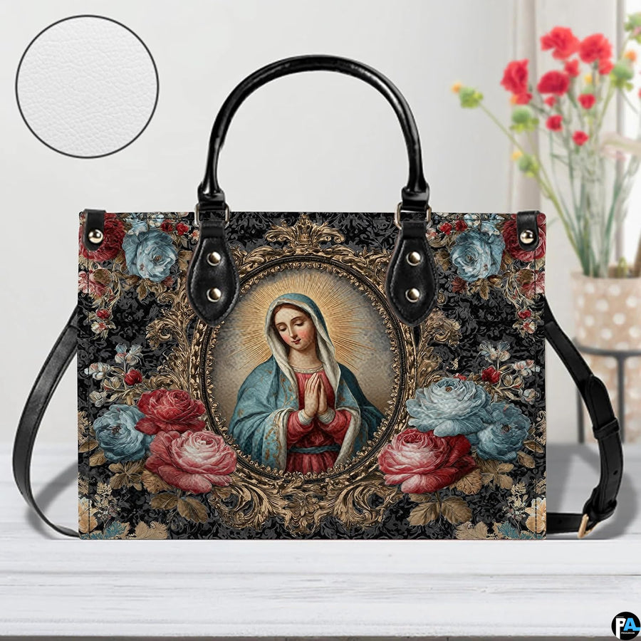 Model walking outdoors carrying Baroque framed Virgin Mary devotional handbag.