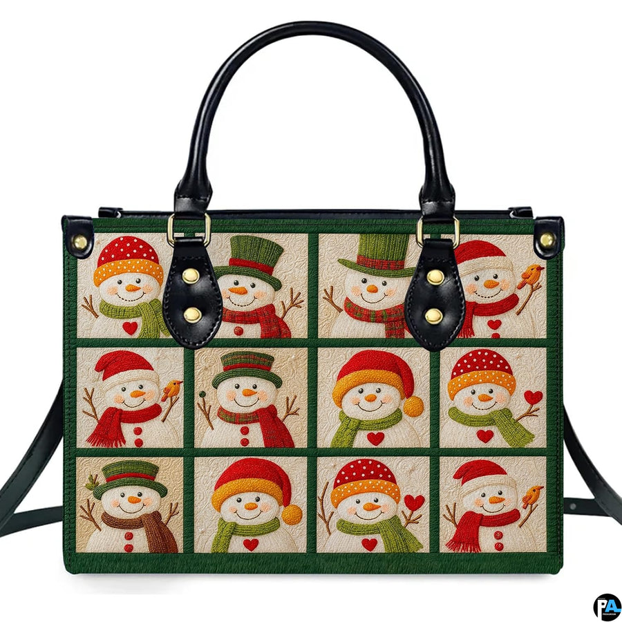 Front view of structured handbag featuring a twelve-block grid of festive snowmen in colorful hats and scarves.