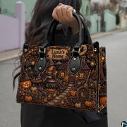 Witch cottage art accessory held outdoors showcasing fairytale garden, illuminated dwelling, and jack-o-lanterns.