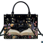 Front studio shot of bookish black cat resting on open book among wildflowers and night starlight.