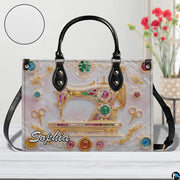 Front studio view highlighting golden sewing machine motif, gemstones, and textured inset disc.