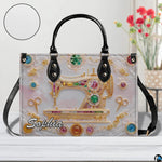 Front studio view highlighting golden sewing machine motif, gemstones, and textured inset disc.