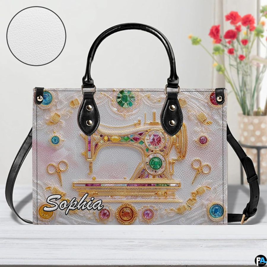 Front studio view highlighting golden sewing machine motif, gemstones, and textured inset disc.