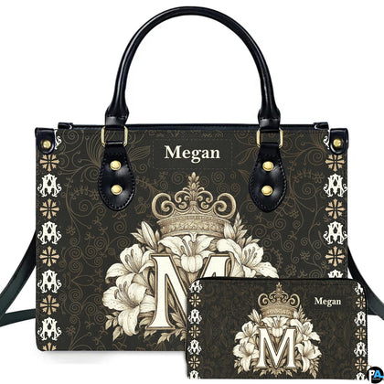 Crowned monogram M lily floral handbag and matching wallet displayed together on clean white backdrop.