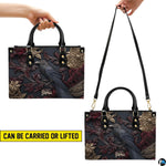 Gothic raven handbag held by top handle while walking outdoors along a residential street.