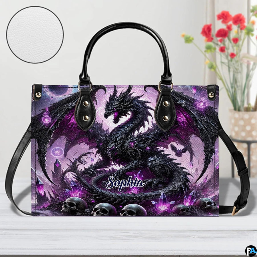 Front view of gothic dragon handbag on white tabletop with circular textured exterior swatch.