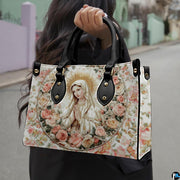 Devotional Virgin Mary floral handbag carried by a model outdoors