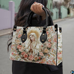 Devotional Virgin Mary floral handbag carried by a model outdoors
