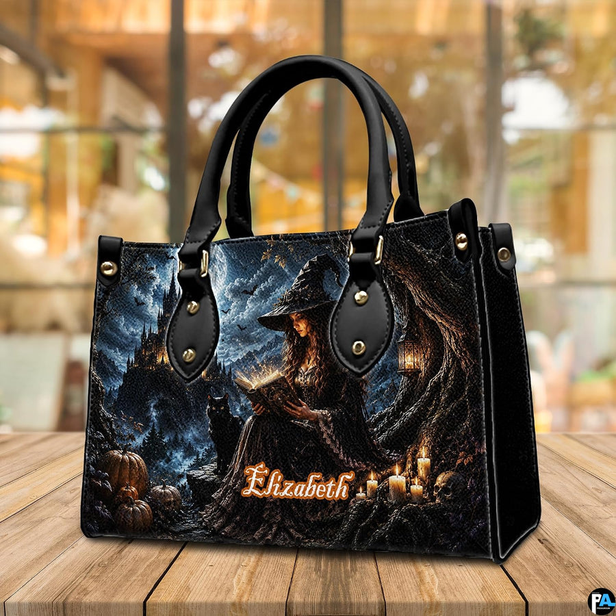 Gothic witch satchel positioned on wooden table with warm ambient cafe bokeh background.