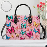 Front tabletop view of colorful butterfly artwork placed beside floral vase and circular texture detail inset.