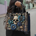 Gothic floral skull grimoire handbag carried by top handles outdoors.