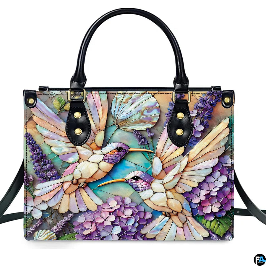 Close-up perspective of opalescent mosaic textures and lavender botanical sprigs on handbag.