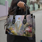 Street lifestyle view of woman carrying Our Lady of Grace wildflower devotional handbag.