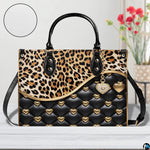 Front view of matching zip wallet with leopard print and quilted heart graphic design.